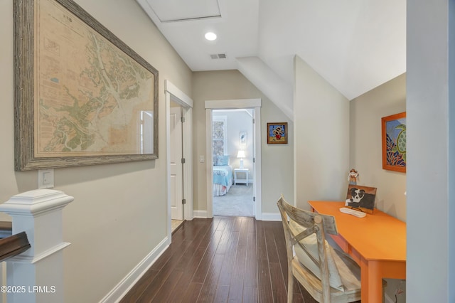 corridor with lofted ceiling and dark hardwood / wood-style floors