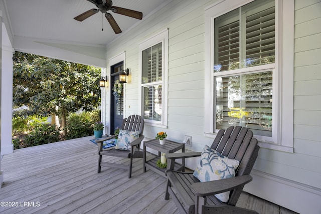 deck with a porch and ceiling fan