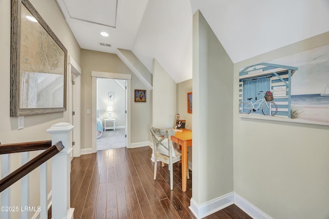 corridor with lofted ceiling and dark hardwood / wood-style flooring