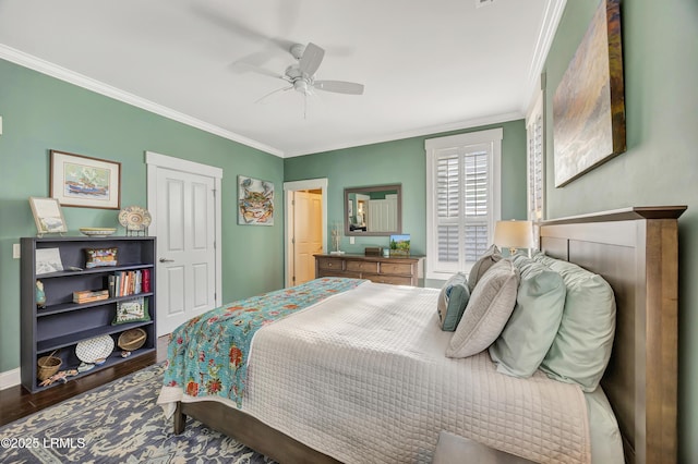 bedroom featuring ceiling fan, ornamental molding, and hardwood / wood-style floors