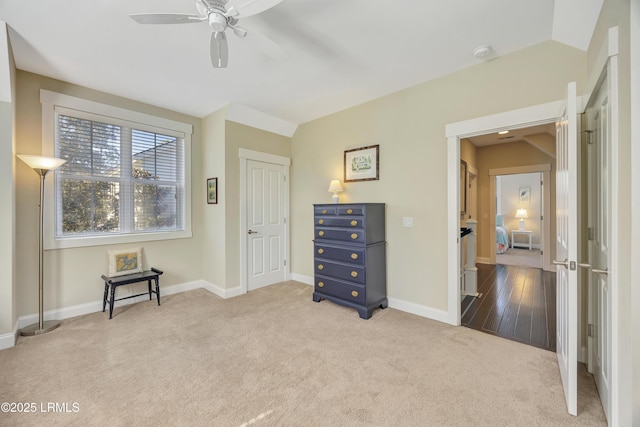 carpeted bedroom with ceiling fan and vaulted ceiling