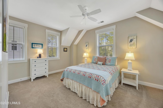 bedroom with light colored carpet, lofted ceiling, and multiple windows