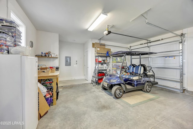 garage featuring a garage door opener, white fridge, and electric panel