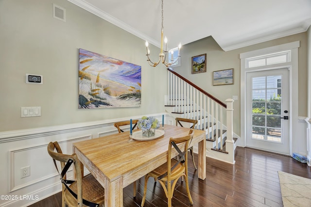 dining area with ornamental molding, dark hardwood / wood-style floors, and a notable chandelier