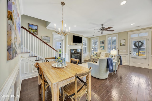 dining room featuring crown molding, dark hardwood / wood-style floors, and a wealth of natural light