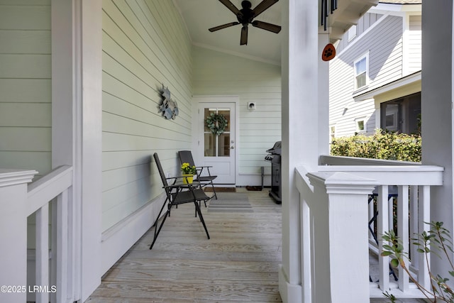 deck with grilling area, covered porch, and ceiling fan