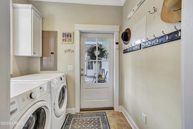 clothes washing area with cabinets, electric panel, and washing machine and dryer