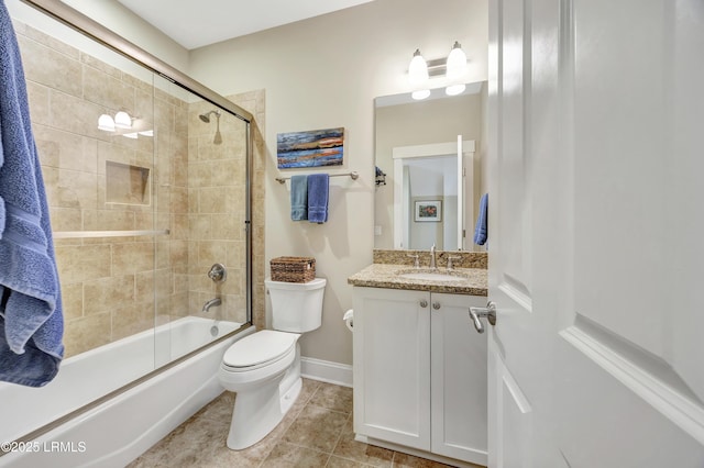 full bathroom featuring tile patterned floors, vanity, toilet, and combined bath / shower with glass door