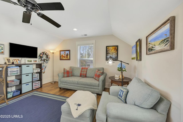 living room featuring hardwood / wood-style floors, vaulted ceiling, and ceiling fan