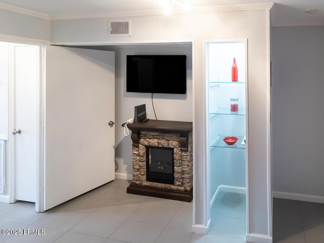 living room featuring crown molding and a stone fireplace