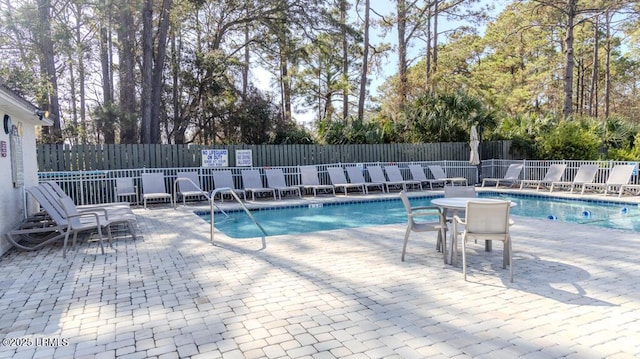 view of swimming pool with a patio