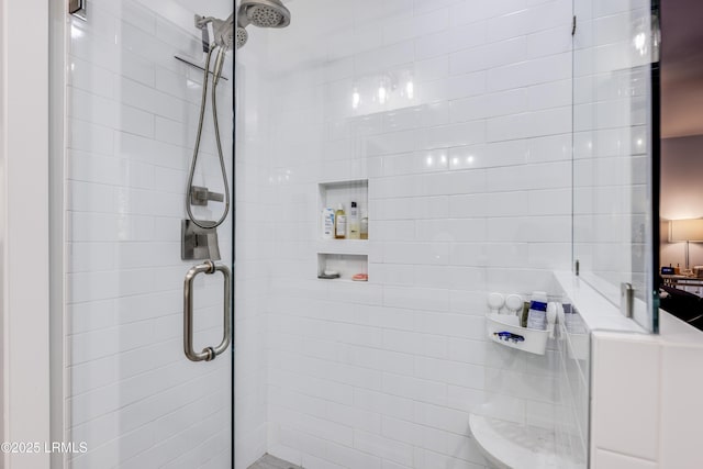 bathroom featuring a shower with door