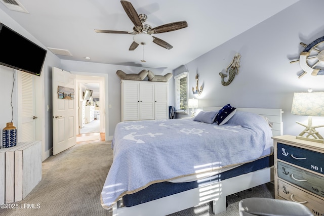 bedroom featuring ceiling fan and light carpet