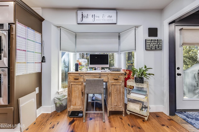 home office featuring plenty of natural light and light wood-type flooring