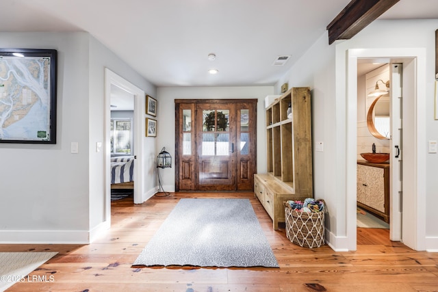 foyer with sink and light wood-type flooring