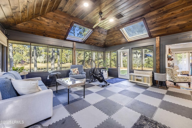 sunroom with a healthy amount of sunlight, vaulted ceiling with skylight, and wooden ceiling