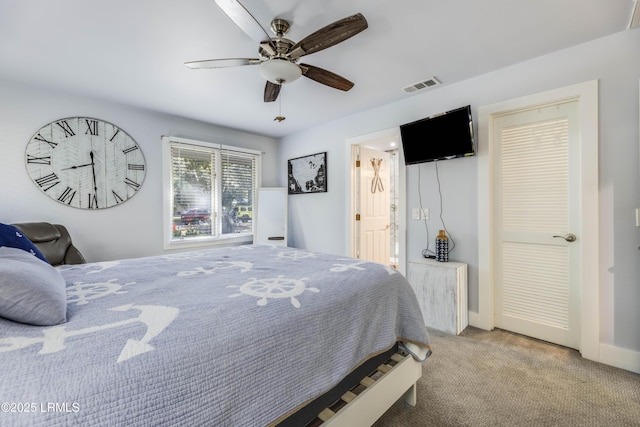 bedroom featuring ceiling fan and light carpet