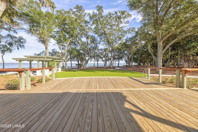 wooden terrace with a pergola, a lawn, and a water view