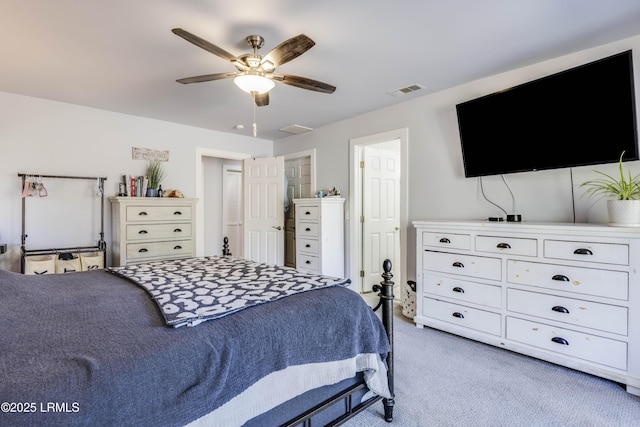 bedroom with ceiling fan and light carpet