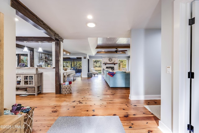 corridor featuring hardwood / wood-style flooring, a wealth of natural light, and beamed ceiling