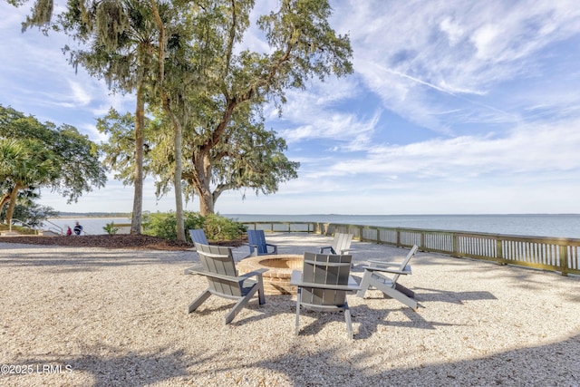 view of patio / terrace with a fire pit and a water view