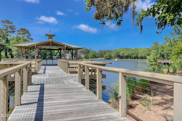 view of dock with a gazebo and a water view