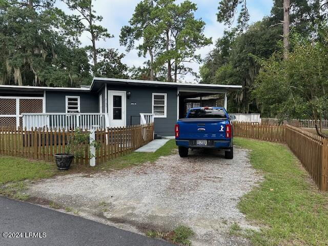 view of front of house with a carport and a porch