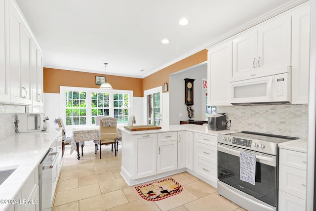 kitchen with stainless steel appliances, white cabinetry, decorative backsplash, and decorative light fixtures