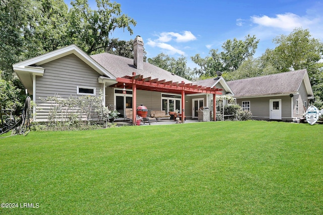 back of property with a patio, a lawn, and a pergola