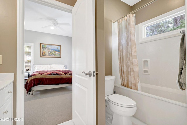 full bathroom featuring vanity, shower / tub combo with curtain, ceiling fan, and toilet