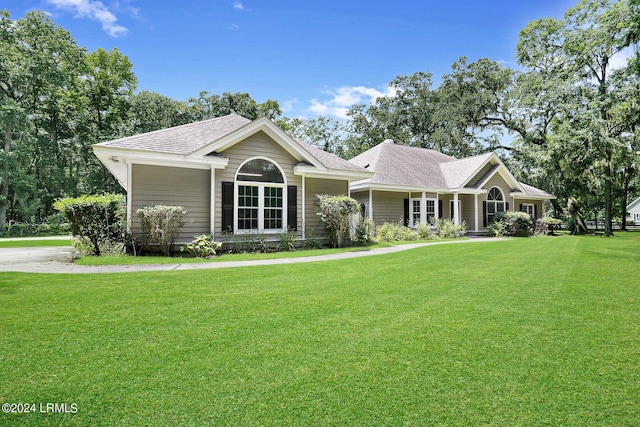 ranch-style home featuring a front yard