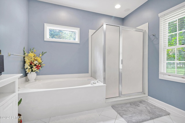 bathroom featuring tile patterned flooring, vanity, and plus walk in shower