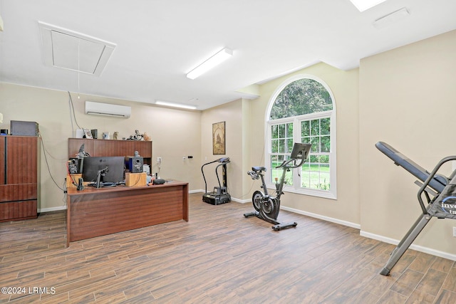 interior space with dark wood-type flooring and a wall unit AC