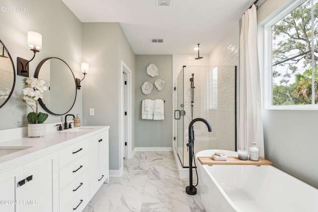 full bath with visible vents, a freestanding tub, a sink, a shower stall, and marble finish floor