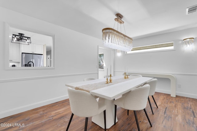 dining room with plenty of natural light and hardwood / wood-style floors