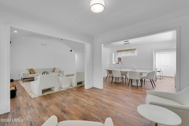 living room featuring hardwood / wood-style floors and ornamental molding