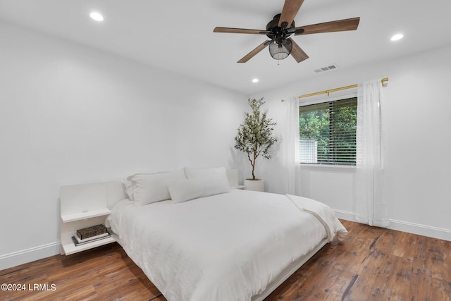 bedroom featuring dark hardwood / wood-style flooring and ceiling fan