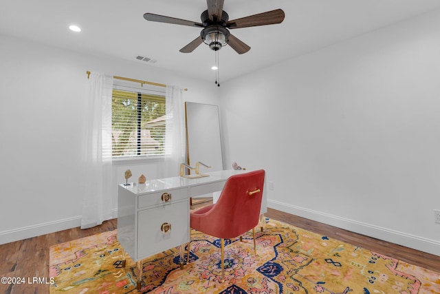 home office with hardwood / wood-style flooring and ceiling fan