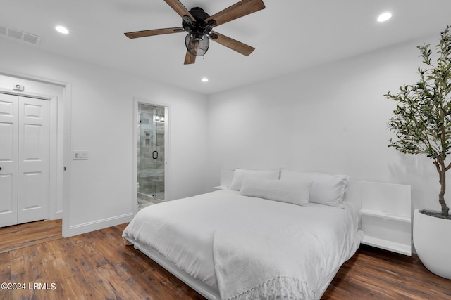 bedroom with a closet, ensuite bath, dark hardwood / wood-style floors, and ceiling fan