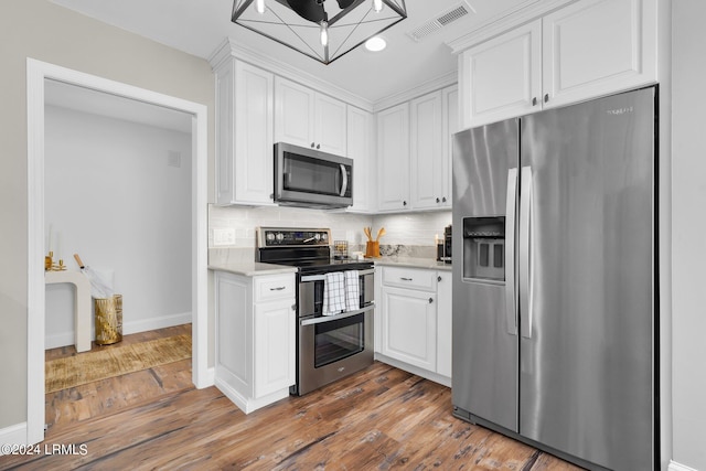 kitchen featuring white cabinetry, tasteful backsplash, stainless steel appliances, and dark hardwood / wood-style floors