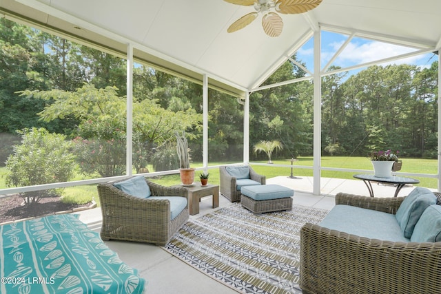 sunroom / solarium featuring lofted ceiling with beams and a ceiling fan