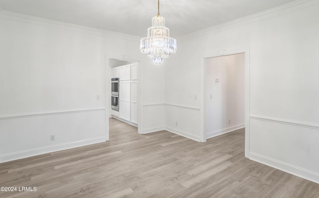 unfurnished dining area with crown molding, a notable chandelier, and light hardwood / wood-style flooring