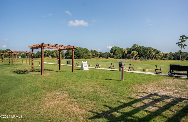 surrounding community with a yard and a pergola