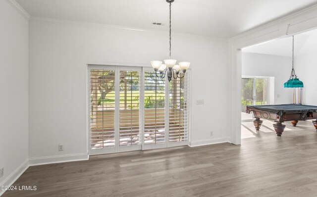 unfurnished dining area featuring billiards, wood-type flooring, a chandelier, and ornamental molding