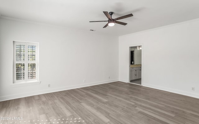 empty room featuring ceiling fan, ornamental molding, and wood-type flooring
