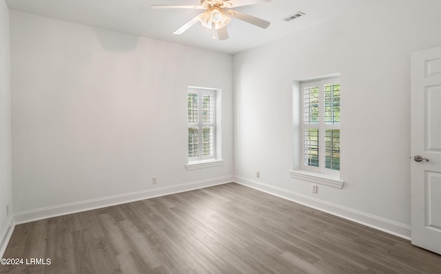 spare room featuring dark hardwood / wood-style flooring and ceiling fan
