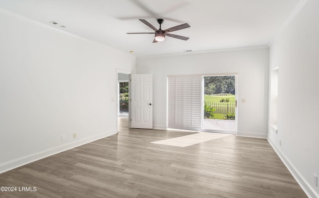 spare room featuring hardwood / wood-style floors, crown molding, and ceiling fan