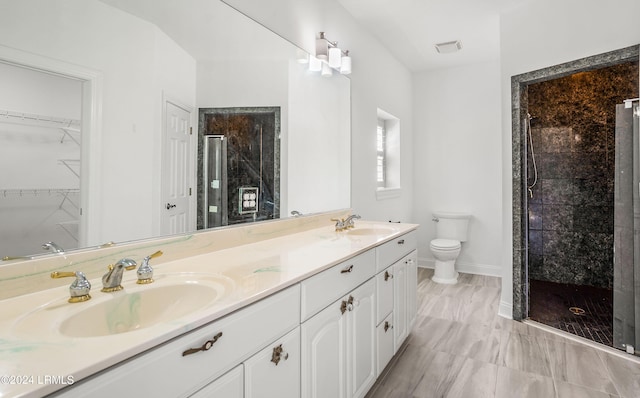 bathroom with walk in shower, vanity, and toilet