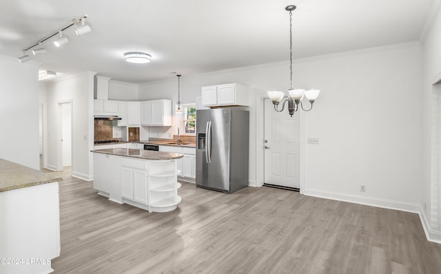 kitchen featuring pendant lighting, sink, stainless steel fridge, white cabinets, and a kitchen island