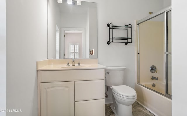full bathroom with bath / shower combo with glass door, vanity, and toilet